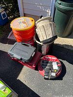 Group shot showing stapler case, air hose, two buckets, and tool cases