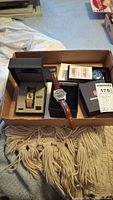 All three watches in tray with boxes