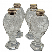 Four matching cut crystal shakers grouped together