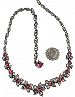 Full view of Bogoff necklace with coin for scale