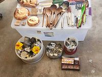 Overall lot on bin and floor showing utensils, knives, copper molds, cookie cutter containers