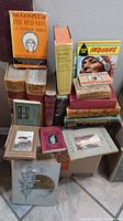 Overall lot showing stacked vintage/antique books