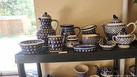 Overall lot on shelving, multiple Polish pottery pieces visible