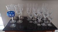Full group of clear and blue lead crystal stemware on tabletop