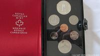 Open case showing red satin lining and full coin set