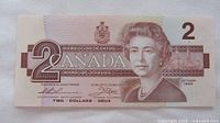 Obverse of 1986 $2 note showing Queen Elizabeth II and denomination