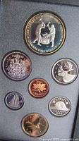 Obverse sides showing commemorative silver dollar and six circulating-design coins