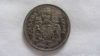 Reverse of 1962 Canadian 50-cent coin showing Coat of Arms and date