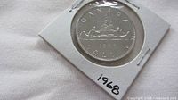 Reverse of 1968 Canadian nickel dollar in holder