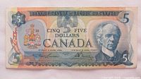 Front view of 1979 Canadian $5 bill showing portrait of Sir Wilfrid Laurier and denomination details