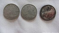 Reverse sides of three Canadian dimes
