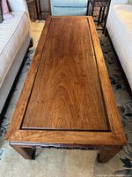 Top view of rosewood coffee table showing single plank surface and beveled edge