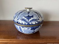 Front view of blue and white porcelain covered jar