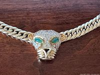 Close-up of leopard head showing diamonds and emerald eyes