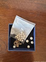 Loose pearls in bag and box with gold-plated chain