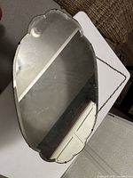 Front view of scalloped wall mirror with chain