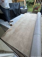 Tan area rug rolled out on deck