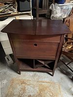 Cabinet closed showing overall shape and front storage sections