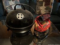 Grill closed beside charcoal bag