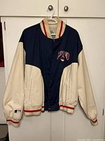 Front view of Cleveland Indians jacket showing two-tone design, snap closure, chest embroidery, sleeve MLB patch