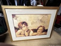 Front view of framed cherub print showing artwork, mat, and frame