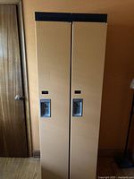Front view of attached orange lockers with chrome recessed handles