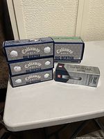 Four Callaway Big Bertha sleeves, larger Callaway box behind, one Ti sleeve