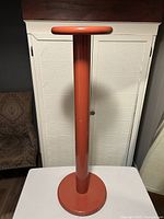 Full view of metal pedestal plant stand showing round top, cylindrical column, and circular base