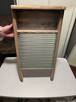 Front view of washboard showing wood frame, glass cleaning surface, and Walter Woods Ltd branding