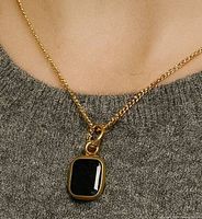 Pendant on chain shown worn for scale