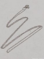 Full view of 16-inch 10K gold chain laid out to show length and link style