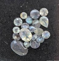 Group of loose faceted gemstones on black background