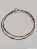 Full view of beaded necklace coiled to show colors and length