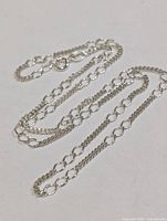 Full view of silver chain laid out showing link pattern