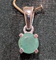 Front view showing emerald stone and silver setting
