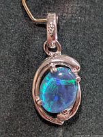 Front view silver pendant with oval opal in open setting