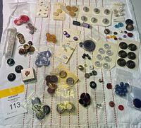 Overview of lot showing assorted buttons on cards, loose buttons and Zip Her box