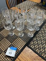 Group of twelve Bohemia crystal wine glasses on table