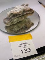 Full view of layered druzy quartz specimen on mirror