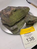 Two epidote and garnet rock specimens on mirror