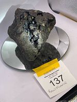 Full view of the raw garnet and epidote specimen on mirror base