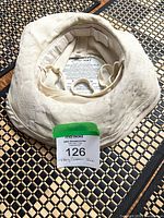 Natural hemp sun hat shown inside-out displaying brim and crown