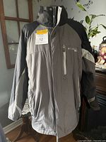 Front view of Columbia grey/black winter jacket on hanger