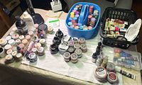 Overall lot of paints, waxes, inks, tubs and tubes on table