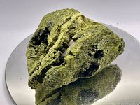 Full view of epidote specimen resting on mirror