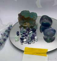 group shot showing rough specimen and tumbled stones on mirror
