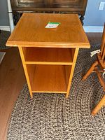Full view of oak-tone solid wood side table front angle