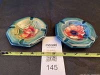 Both Moorcroft ashtrays front view with measuring tape showing width