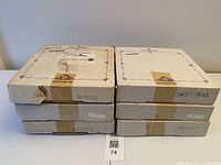 Six boxed plates stacked showing pattern labels