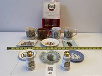 Group overview of all commemorative items including mugs, dishes, shakers and boxed goblets